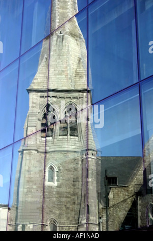 Vecchia chiesa riflessa nella lastra di vetro per finestre del nuovo edificio per uffici Foto Stock