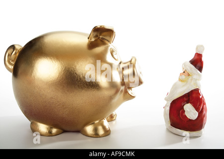 Golden salvadanaio e santa claus figurina Foto Stock