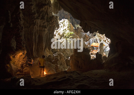 I turisti con le torce esplorare la galleria principale nel Tham Phu Kham (Poukham) grotta bocca, vicino a Vang Vieng. Laos Foto Stock