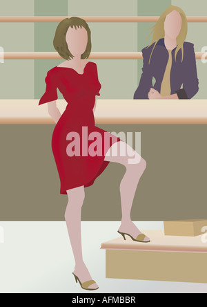 La donna in piedi di fronte a un contatore Foto Stock