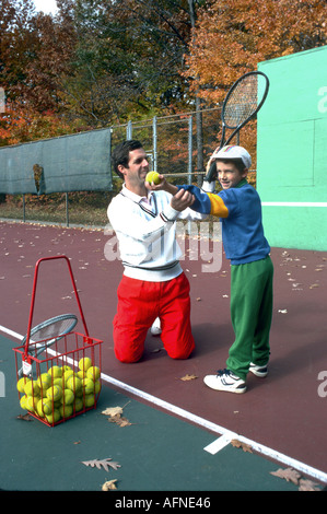 Giocatore di tennis professionista padre figlio insegna a giocare a tennis Foto Stock
