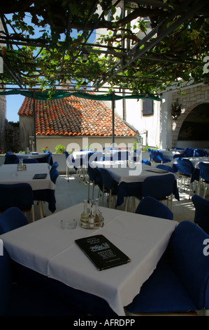 I menu e le tabelle sotto vitigno Mali Raj Ristorante nella città vecchia di Rovigno Istria Croazia Foto Stock