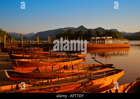 Vista su imbarcazioni a remi & cruiser sul lago Derwentwater verso Cat le campane in tarda serata luce Foto Stock