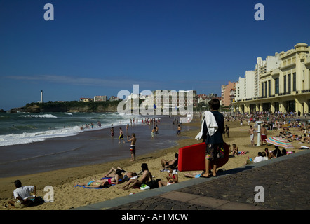 Il lungomare e la passeggiata lungomare di Biarritz, Francia Europa con lucertole da mare e il corpo del surfista in primo piano e il faro Foto Stock