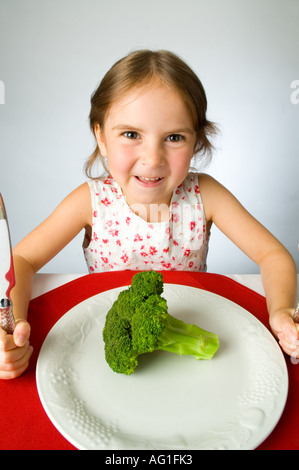 Ragazza giovane non è contento di dover mangiare broccoli Foto Stock