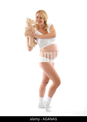 Donna incinta holding orsacchiotto modello rilasciato Foto Stock