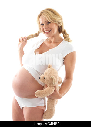 Donna incinta holding orsacchiotto modello rilasciato Foto Stock