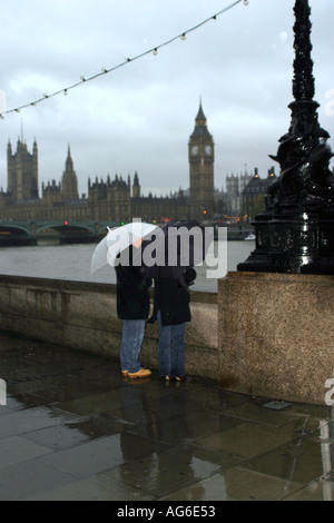 I turisti sulla sponda meridionale del fiume Tamigi con le case del Parlamento in background Foto Stock