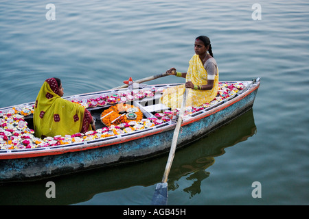 Due donna in una barca sul fiume Gange vendere deepak o lampade a olio del Fiume Gange Varanasi india Foto Stock