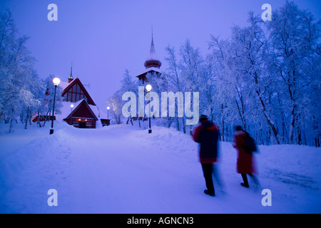 La gente camminare in inverno al di fuori della Chiesa di Kiruna Kiruna Svezia Foto Stock