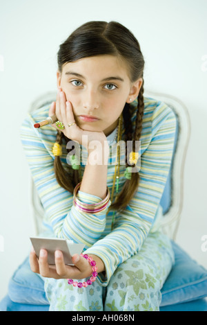 Ragazza con specchio a mano e il rossetto, guardando triste Foto Stock