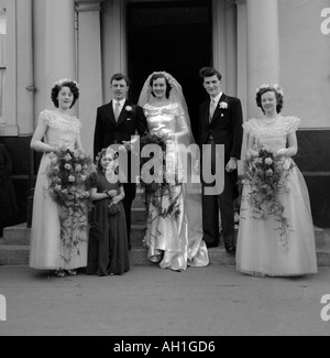 Vecchia famiglia vintage fotografia istantanea di sposa sposo uomo migliore e spose cameriere nel gruppo a Wedding Foto Stock