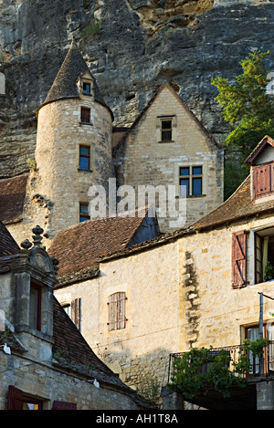 Facciata ripida roccia presso La Roque Gageac Dordogna nel tardo pomeriggio di sole con edifici sulla collina Foto Stock