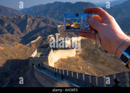 La Grande Muraglia a Badaling vicino a Pechino con una stretta di mano in possesso di una fotocamera digitale Foto Stock