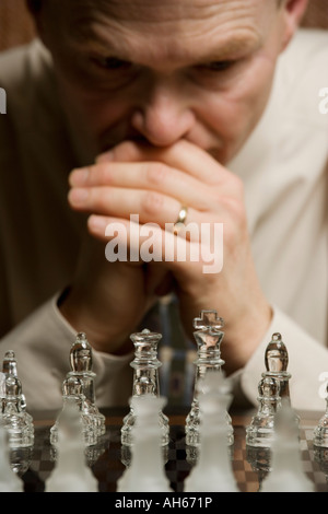 L'uomo concentrando sulla partita a scacchi Foto Stock