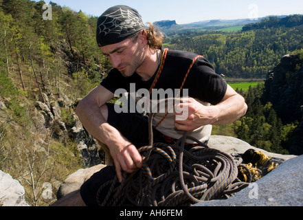 Free climber corda di bobinatura sulla sommità della roccia Hirschgrund Elbe montagne di arenaria Germania Foto Stock