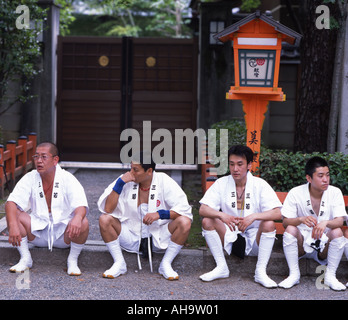 Giapponese uomini seduti fuori il santuario Yasaka durante il Festival di Gion Foto Stock