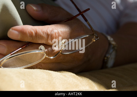 Bicchieri detenute in Senior mano d'uomo Foto Stock