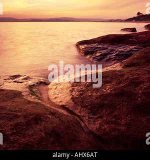 Arancione tramonto dal punto Orcombe vicino a Exmouth, Devon, Regno Unito Foto Stock