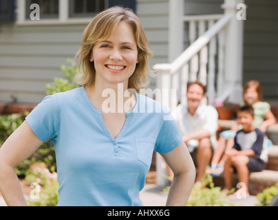 Ritratto di donna con la famiglia in background Foto Stock