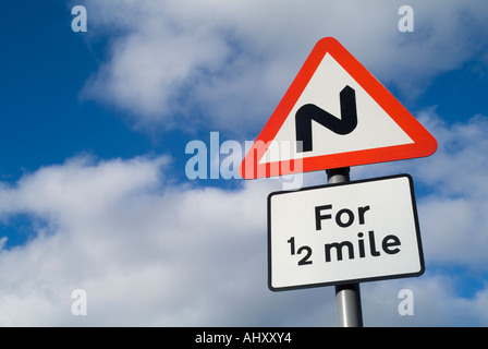 dh Red Triangle segnaletica STRADALE UK Twisty Road curva per 1/2 miglia paese segno segnaletica segnaletica segnaletica segnaletica segnaletica segnaletica di attenzione Foto Stock