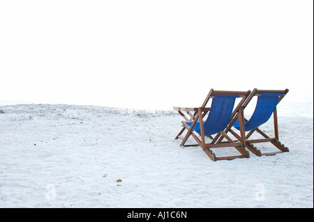 Due sedie a sdraio sulla spiaggia vuota Foto Stock