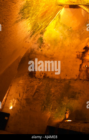 Nella cantina sotterranea che è una vecchia cava di gesso: un camino di ventilazione e una statua, Champagne Ruinart, Reims, Champagne, Marne, Ardenne, Francia, bassa luce grano sgranate Foto Stock