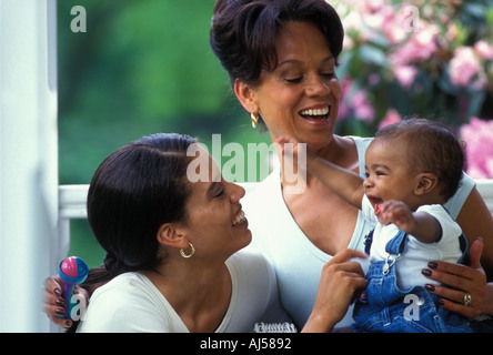 African American figlia della madre, baby la condivisione di un momento felice sulla loro parte anteriore portico Foto Stock