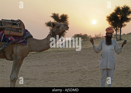 Uomo con un cammello nel deserto del Thar in Rajasthan, India Foto Stock