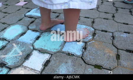 Bambina permanente sulla street painting Foto Stock