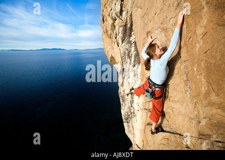 Scalatore afferra un attesa durante la salita. Foto Stock