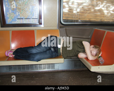 Ragazza distesa sul sedile al di sotto della mappa della metropolitana di New York Metro Manhattan STATI UNITI D'AMERICA Foto Stock