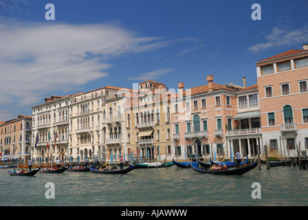 Fila di case in stucco e gondolieri solcare il Canal Grande a Venezia Italia Foto Stock