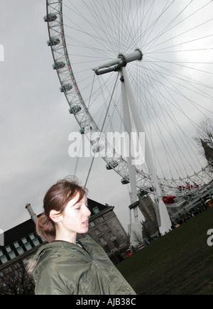 Ragazza adolescente in parka di fronte a London Eye Foto Stock