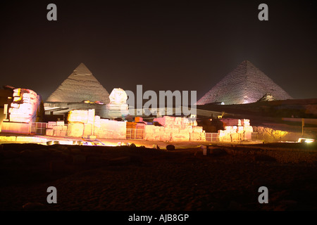 Piramidi e Sfinge accesa durante la drammatica sera Son et Lumiere o spettacolo di suoni e luci di notte o in Giza Cairo Egitto Foto Stock