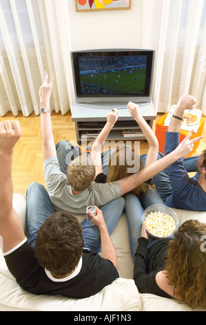 Gli Amici di guardare la TV e di celebrare, vista da sopra Foto Stock