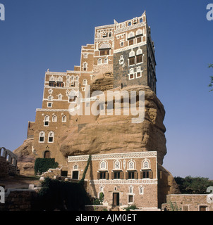 Guardando il famoso Dar Al Hajar Rock Palace che mostra chiaramente come essa è costruita su un solido basamento in pietra rock formazione in Yemen Foto Stock