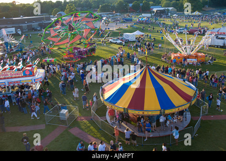 Una spettacolare veduta aerea di un piccolo viaggio Carnevale americano con colorate [colorato] giostre e una folla di gente. Foto Stock