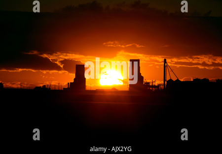 Sun impostazione tra Tuxford elevatori della granella Foto Stock