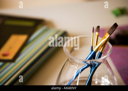 Vernice blu spazzole nel vasetto di vetro Foto Stock