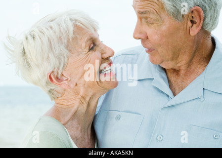 Coppia senior guardando ogni altra donna sorridente, uomo sollevando le sopracciglia Foto Stock