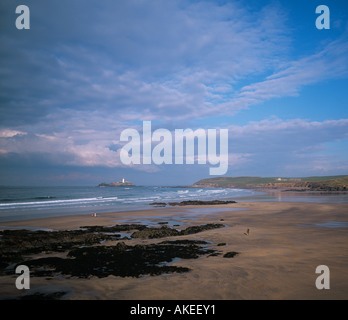 Godrevy point con bianco faro da Gwithian Towans attraverso St Ives Bay con onde che si infrangono sulla vasta spiaggia di sabbia della Cornovaglia Foto Stock