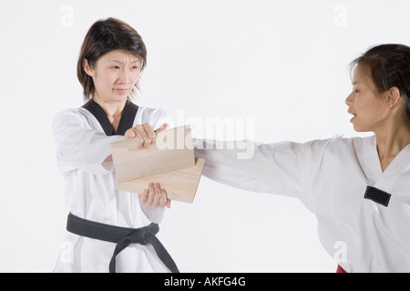 Femmina istruttore di karate insegnando le arti marziali per una giovane donna Foto Stock