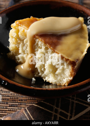 Una fetta di tradizionale South African Malva pudding vegetariano cibo editoriale Foto Stock