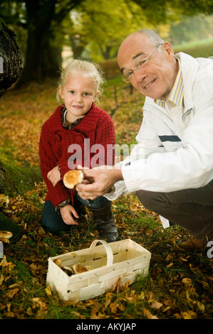 Germania, Baden-Württemberg, montagne sveve, nonno e nipote alla ricerca di funghi nella foresta, ritratto Foto Stock