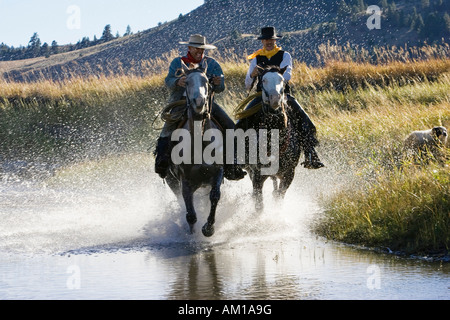Cowboy a cavallo in acqua, wildwest, Oregon, Stati Uniti d'America Foto Stock