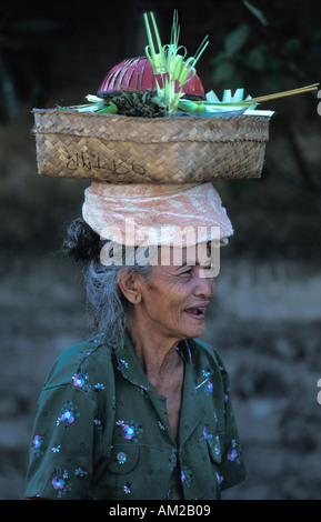 Donna Balinese arriva al tempio con un religioso che offre luna piena celebrazioni Ubud Bali Indonesia Foto Stock