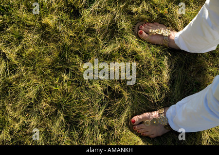 Una donna e in piedi in piedi in erba Foto Stock