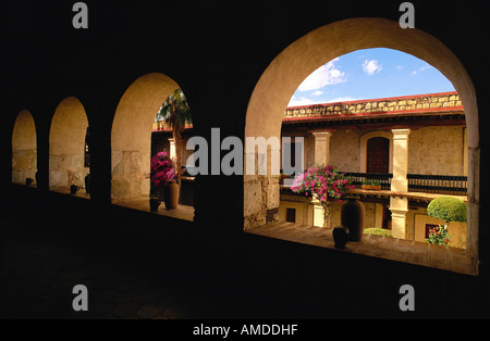 Fiori in finestre ad arco, Hotel Camino Real, Oaxaca, Messico Foto Stock