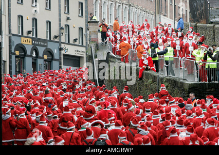 Oltre 10000 persone vestite come santa claus tenta il Guinness World Record a piedi lungo pareti Derrys Irlanda del Nord Foto Stock
